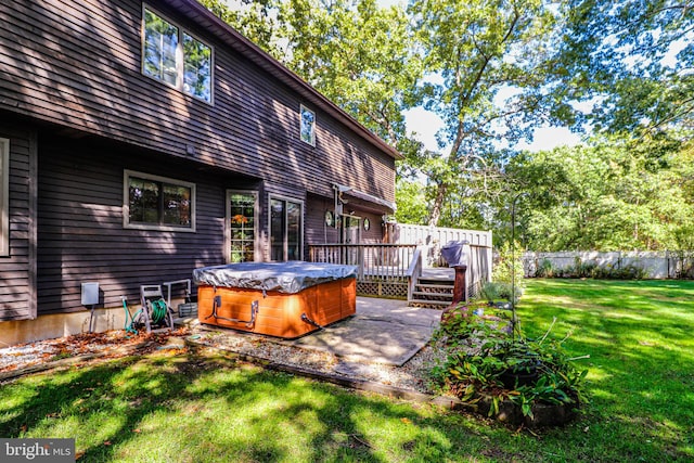 exterior space with a hot tub and a wooden deck