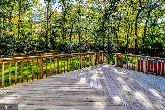 wooden terrace with a lawn