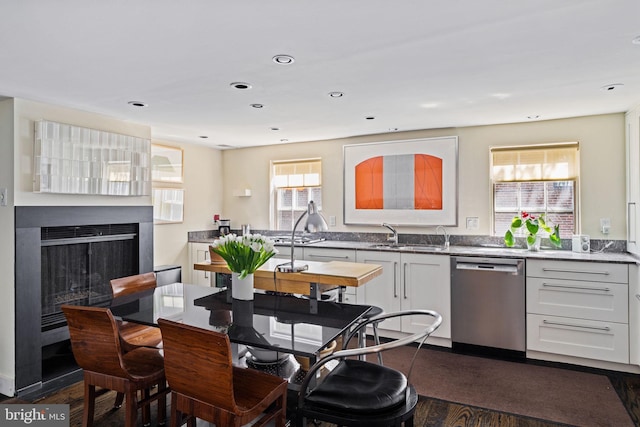 kitchen with dishwasher, dark hardwood / wood-style floors, white cabinetry, and a healthy amount of sunlight