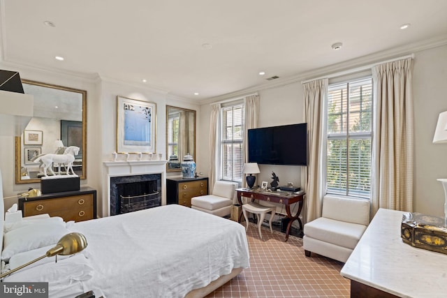 bedroom with a premium fireplace and ornamental molding