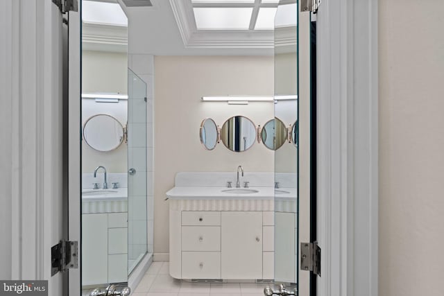 bathroom featuring walk in shower, vanity, crown molding, and tile patterned floors