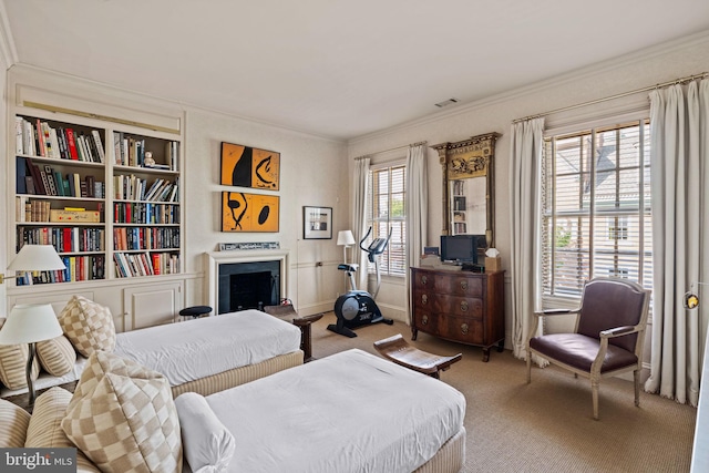 bedroom with crown molding, carpet, and multiple windows