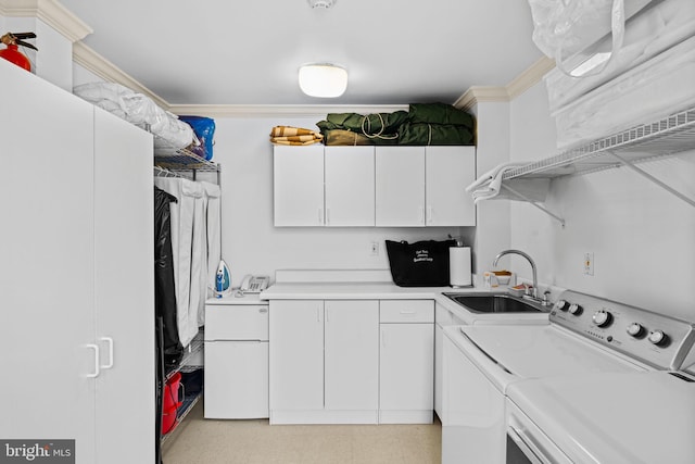 interior space with sink, crown molding, independent washer and dryer, and white cabinetry