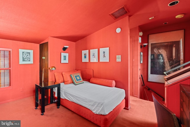 bedroom with light colored carpet and vaulted ceiling