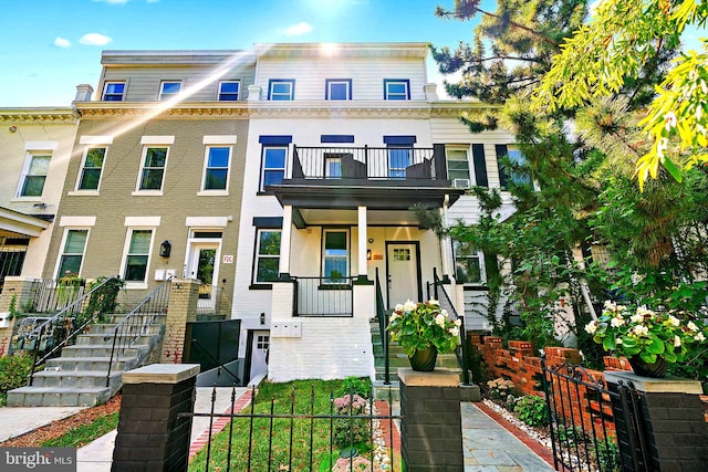 multi unit property featuring a balcony and a porch