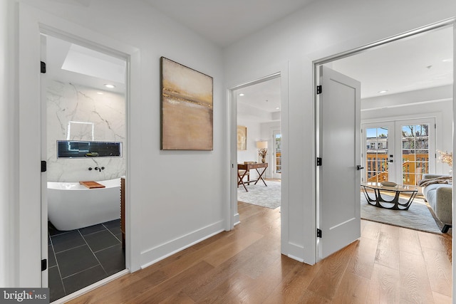 hallway featuring wood-type flooring and french doors