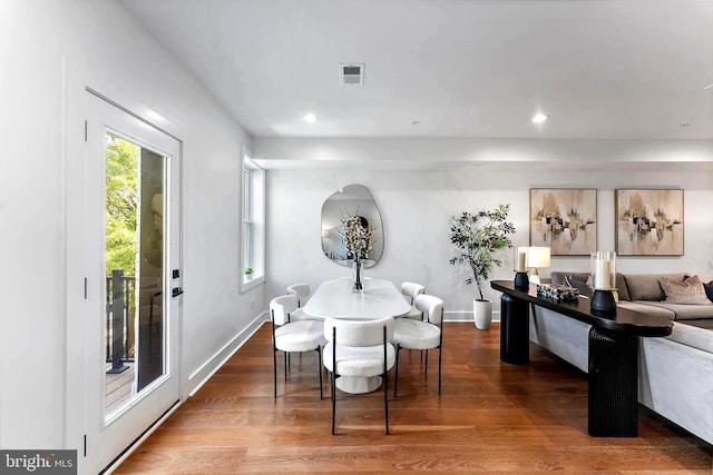 dining space with wood-type flooring