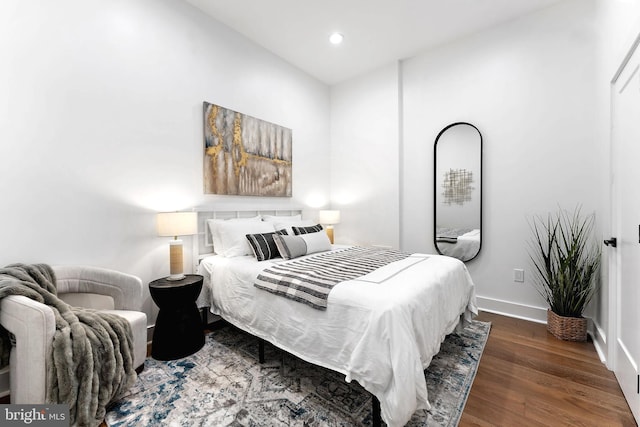 bedroom with dark hardwood / wood-style floors