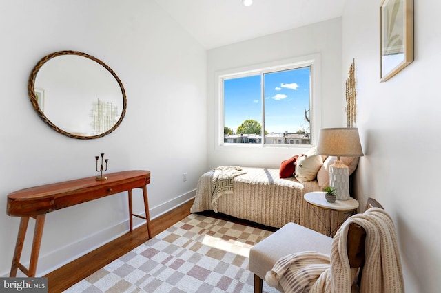 bedroom featuring light hardwood / wood-style flooring and vaulted ceiling