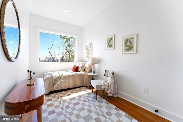 bedroom featuring vaulted ceiling and hardwood / wood-style floors