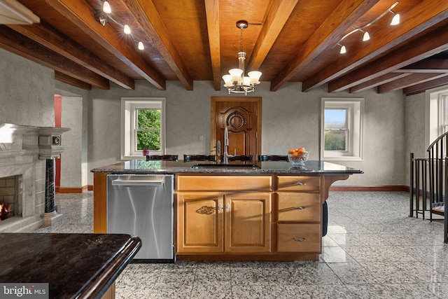 kitchen with a fireplace, dishwasher, beam ceiling, decorative light fixtures, and sink