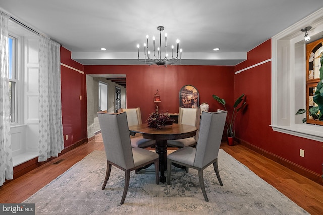 dining room with a chandelier and hardwood / wood-style floors