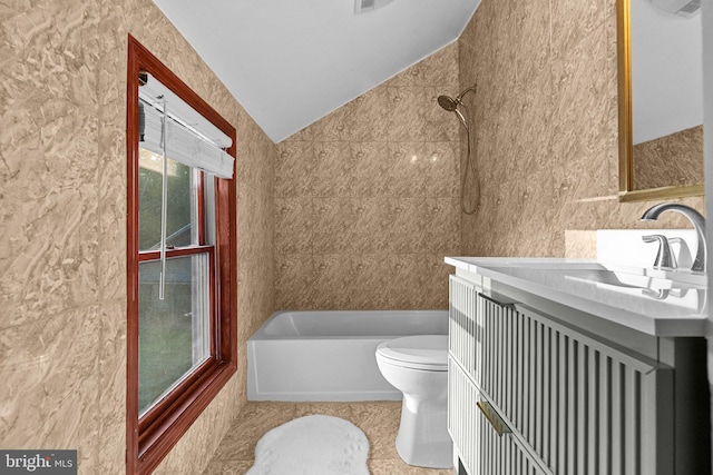 full bathroom featuring tile walls, vanity, tiled shower / bath combo, toilet, and tile patterned floors