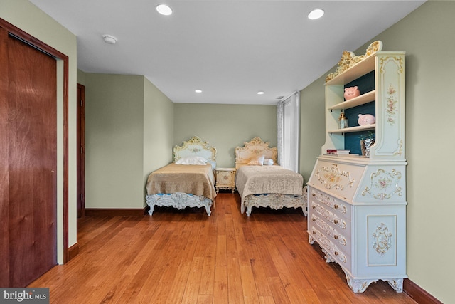 bedroom with light wood-type flooring and a closet