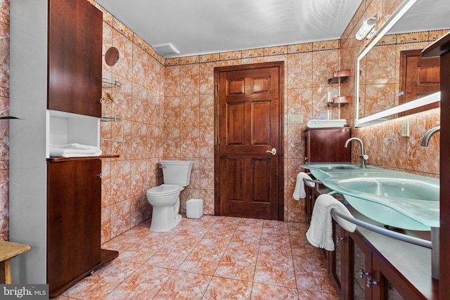 bathroom featuring tile walls, tile patterned flooring, vanity, and toilet