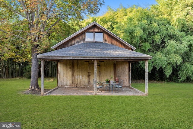 view of outbuilding featuring a lawn