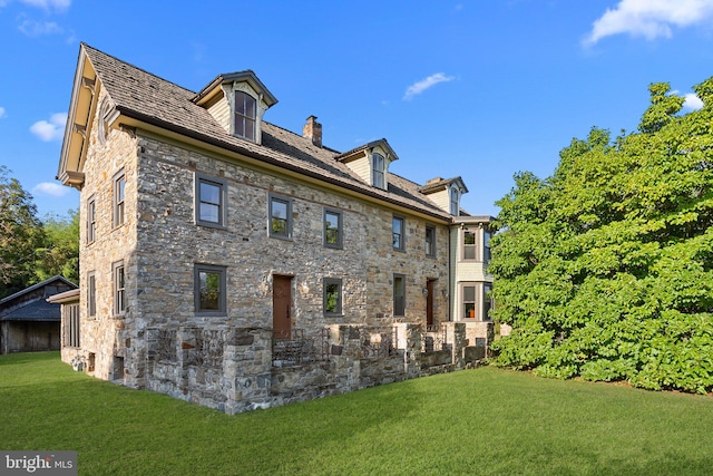 view of side of property with a yard