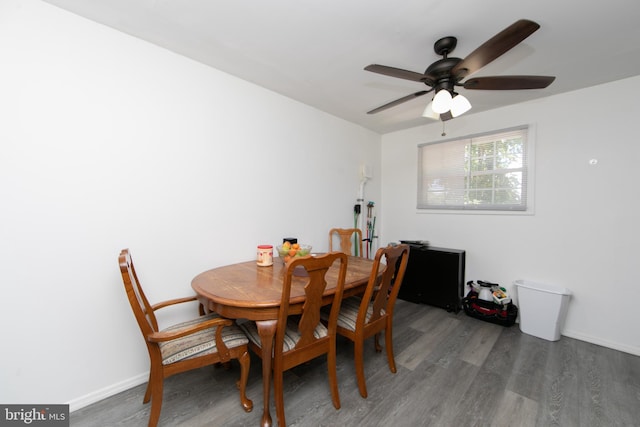 dining room with ceiling fan and dark hardwood / wood-style flooring