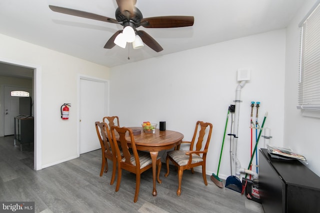 dining space with wood-type flooring and ceiling fan