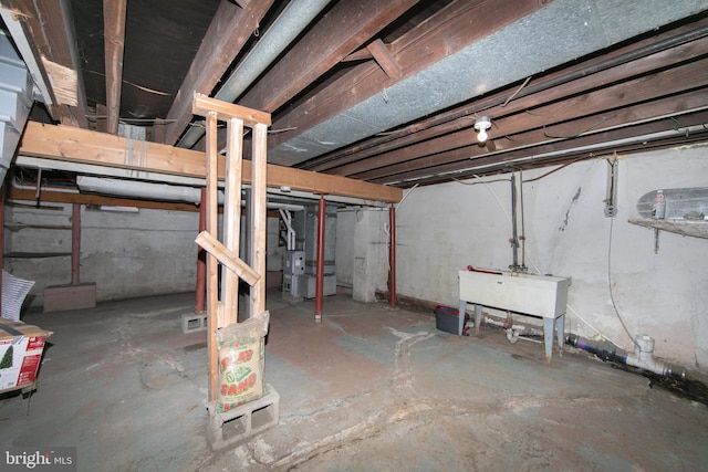 basement with heating unit and sink