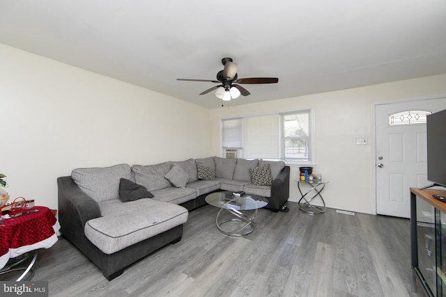 living room with light wood-type flooring and ceiling fan