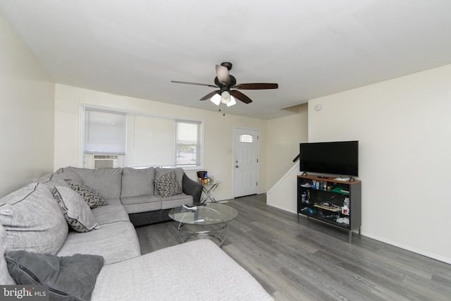 living room with dark wood-type flooring and ceiling fan