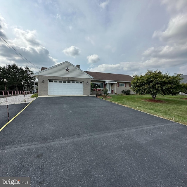 view of front of house featuring a garage and a front lawn