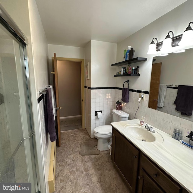 bathroom featuring vanity, tile walls, and toilet