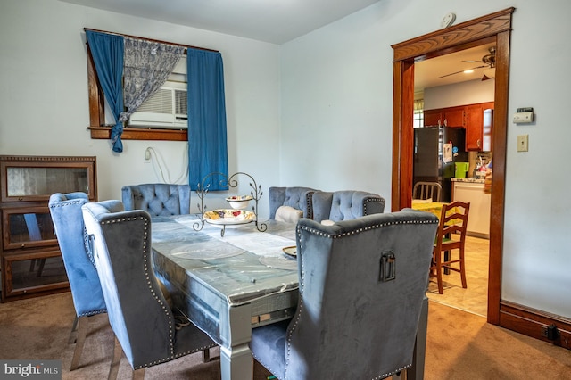 dining room with ceiling fan and light colored carpet