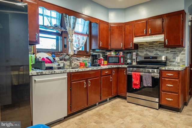 kitchen featuring stainless steel appliances, sink, and decorative backsplash