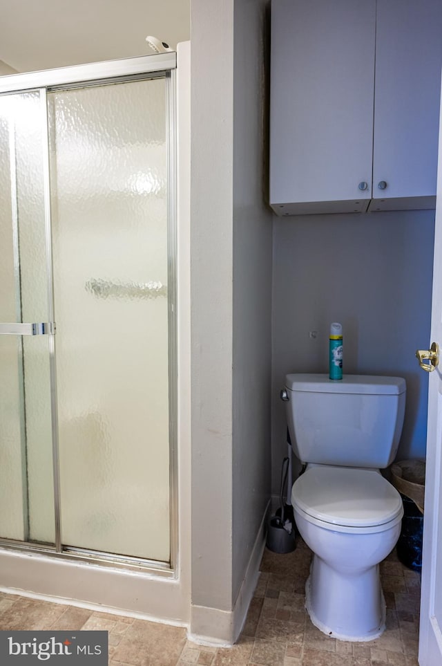 bathroom with walk in shower and toilet