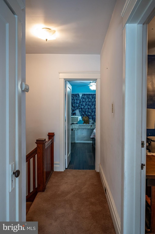 corridor with dark colored carpet