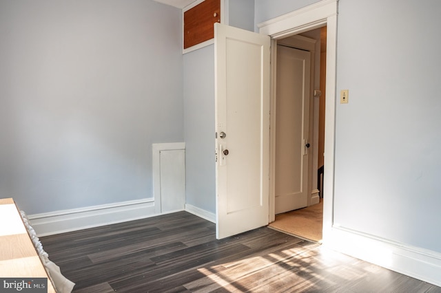 empty room featuring dark wood-type flooring