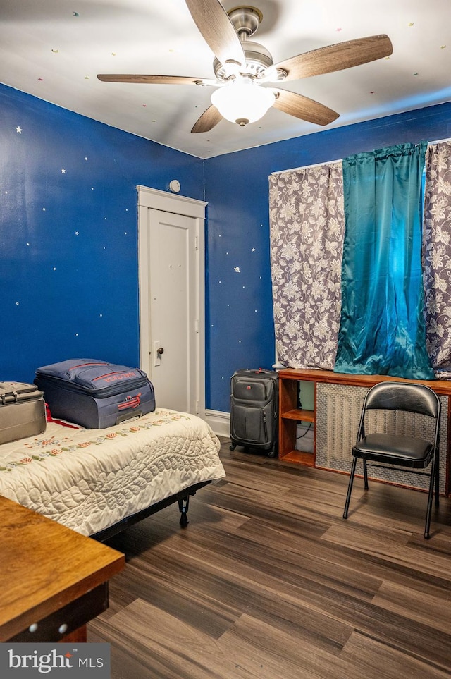 bedroom with wood-type flooring and ceiling fan