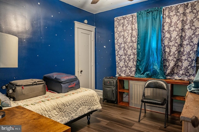 bedroom with ceiling fan and dark hardwood / wood-style flooring