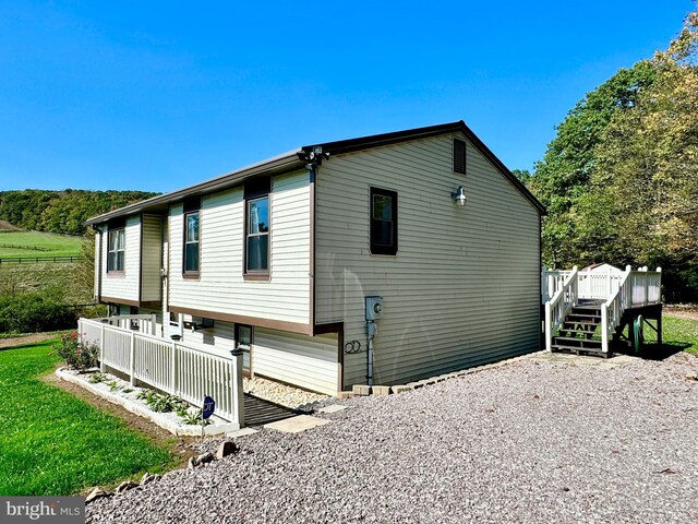 view of home's exterior with a wooden deck