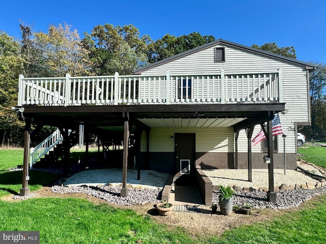 rear view of house with a wooden deck