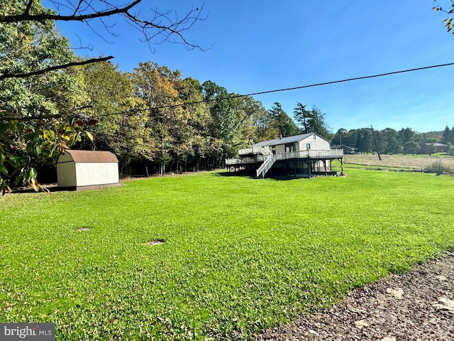 view of yard featuring a shed and a deck