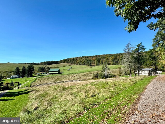 view of home's community featuring a rural view and a lawn
