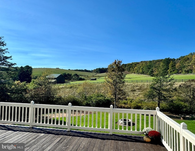 wooden terrace featuring a rural view