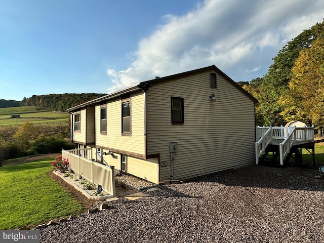 view of side of home with a deck