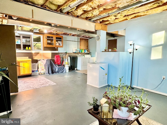 unfinished below grade area with independent washer and dryer and fridge