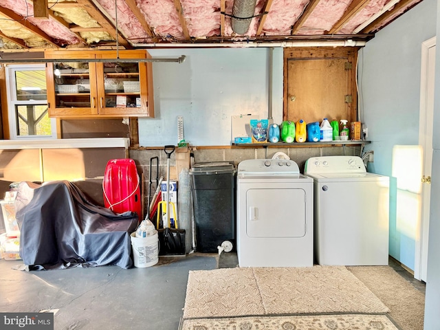 clothes washing area with washing machine and dryer