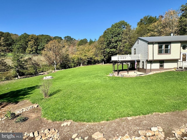 view of yard with a patio and a wooden deck