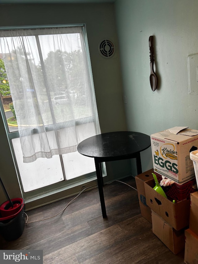 dining space featuring plenty of natural light and dark hardwood / wood-style floors