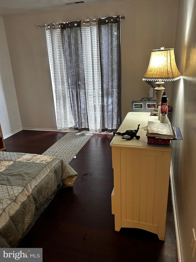 bedroom with dark wood-type flooring