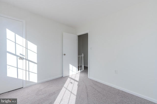 empty room featuring light carpet