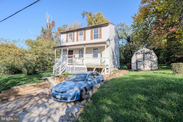 view of front of property featuring a porch and a storage shed