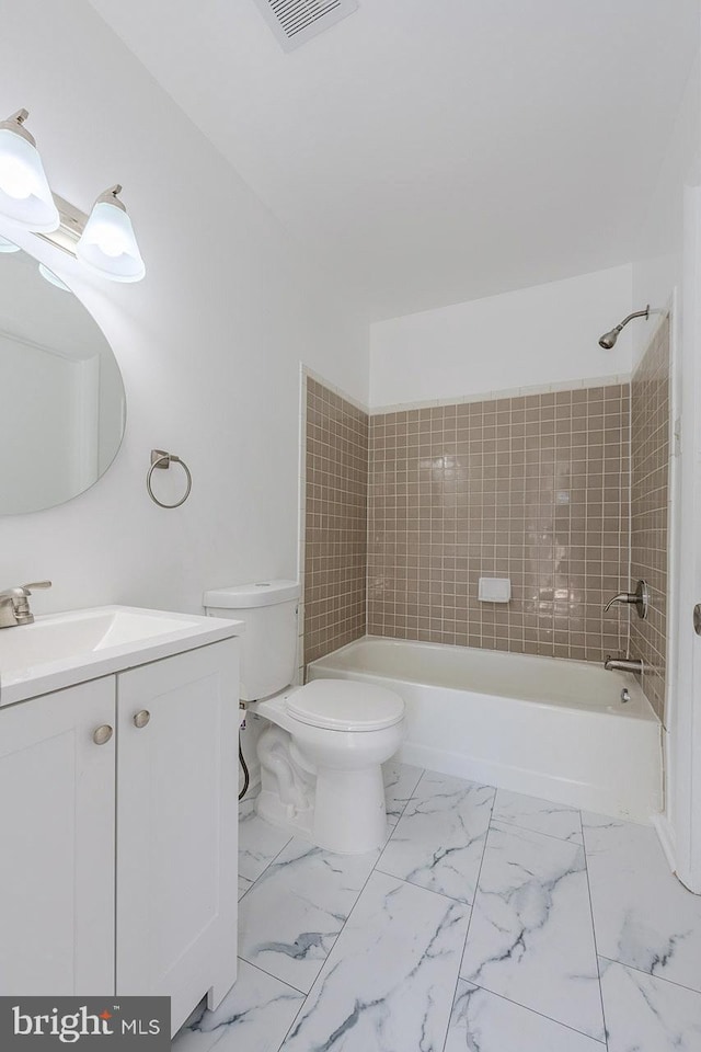 full bathroom featuring vanity, toilet, and tiled shower / bath