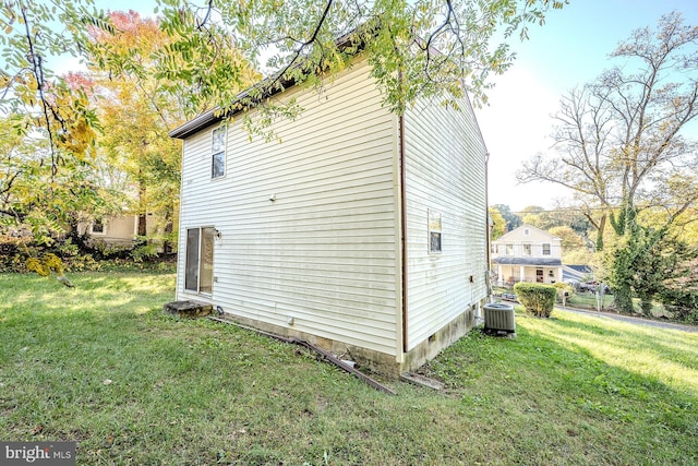 view of property exterior featuring a yard and central AC